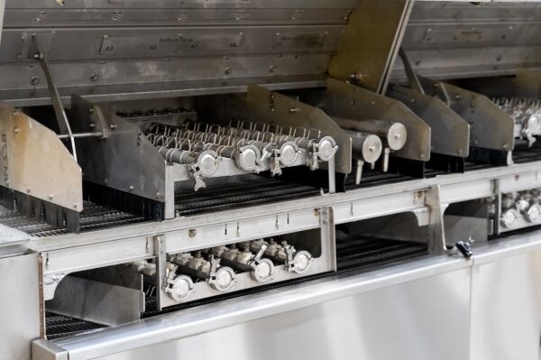 c-14 industrial parts washer on factory floor stainless steel close up
