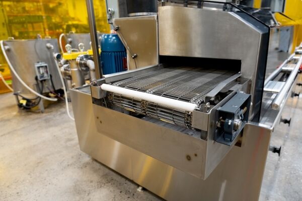 c-14 industrial parts washer on the factor floor close up of conveyor