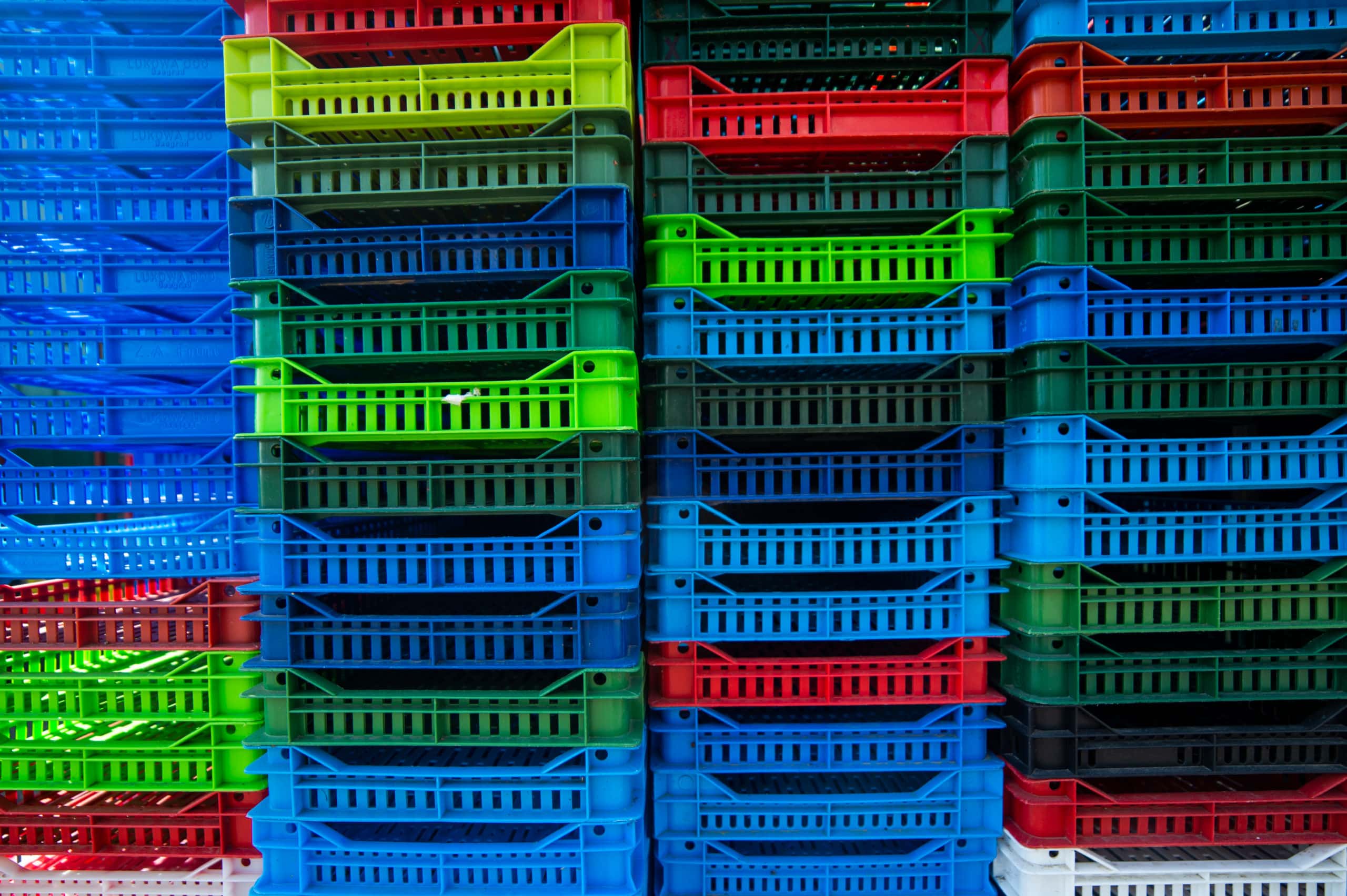 Crates Stacked at a Distribution Center to be cleaned with pallet washing system.