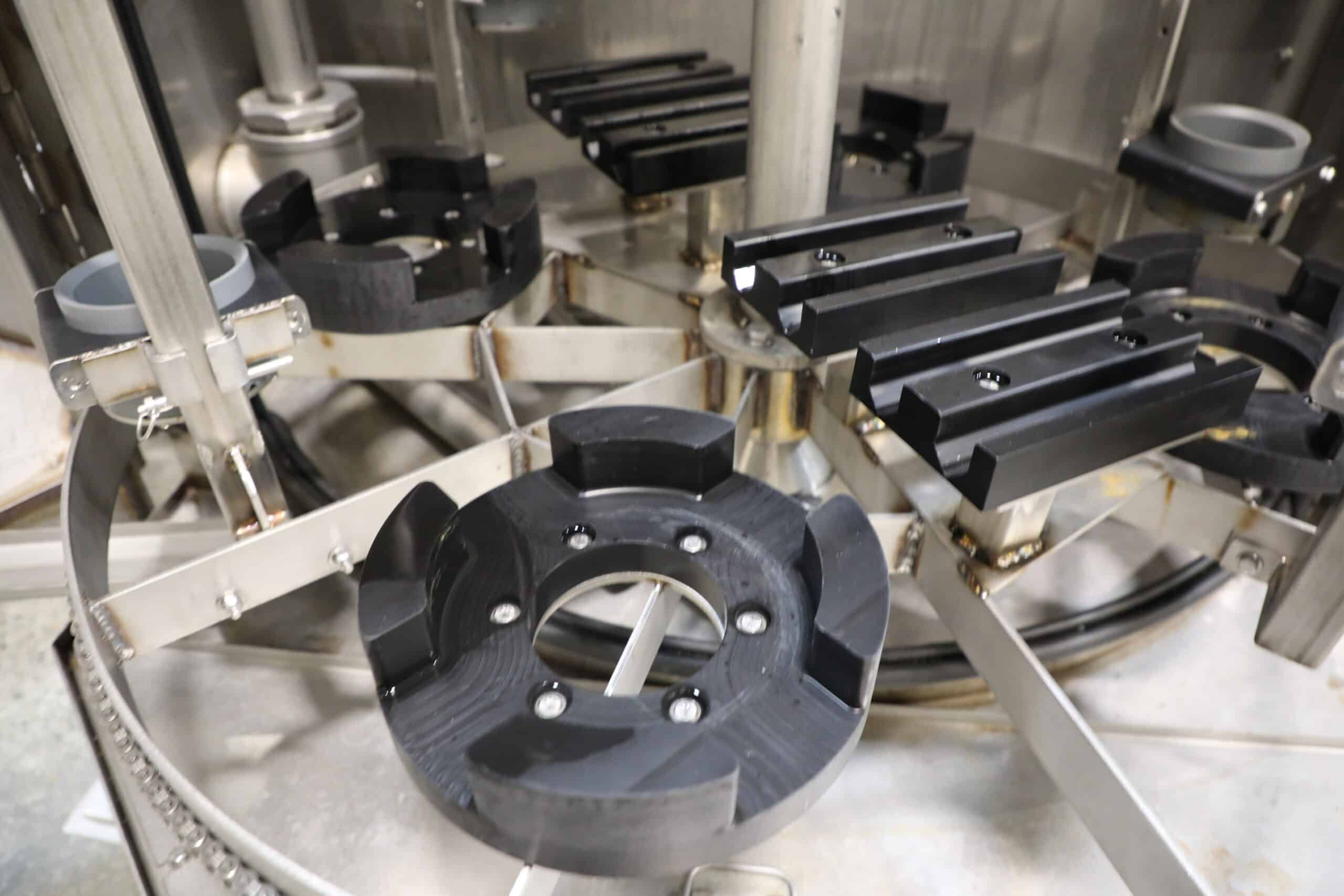 Turntable part washer with custom fixturing that effectively cleans heat exchangers and small bundles of tubes.