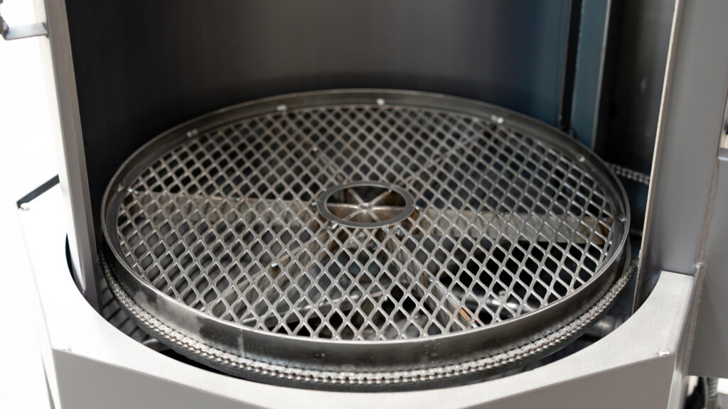 Close-up view of the stainless steel turntable inside a Better Engineering Genesis parts washer.