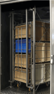 Totes inside of rack washer. Sanitizing rack washers can be designed for high-volume cleaning.