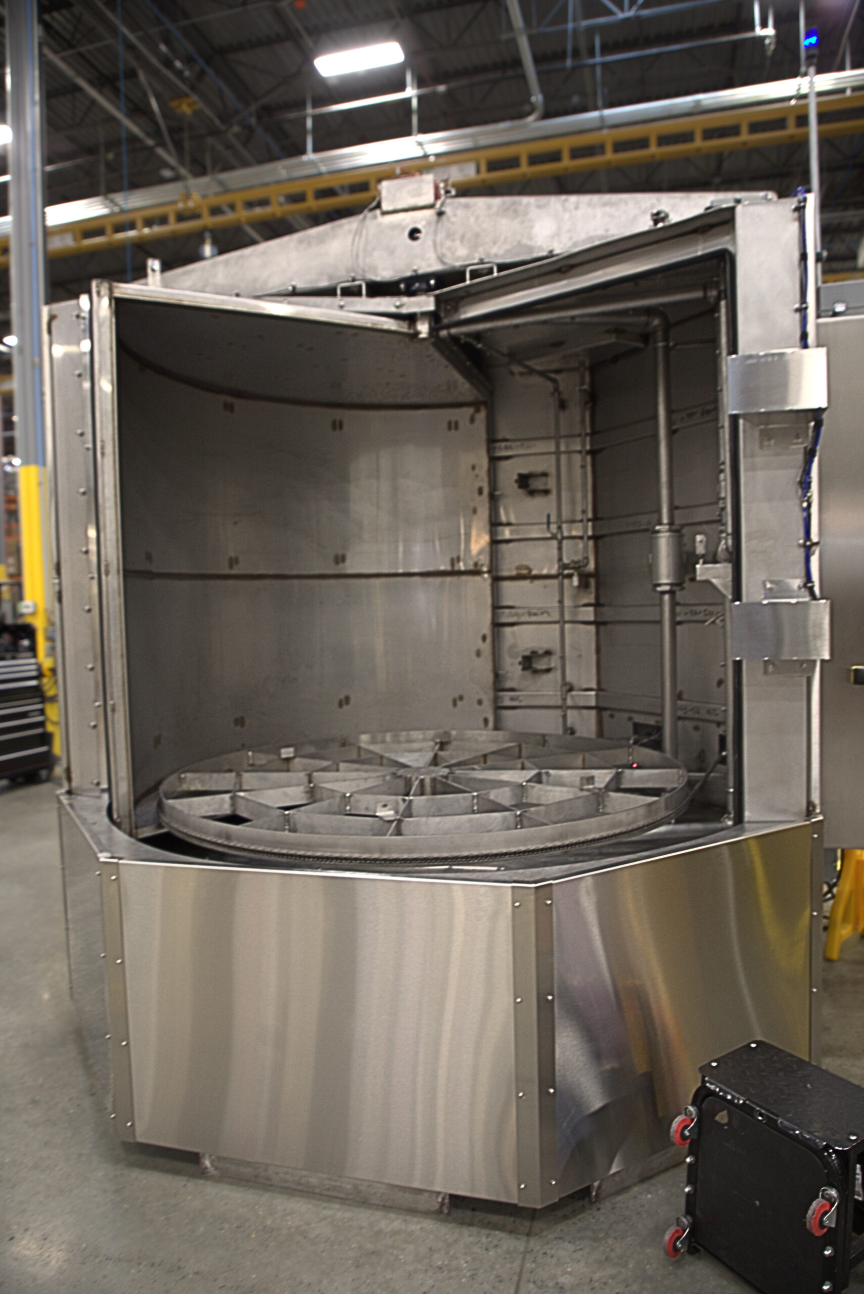 Better Engineering stainless steel sanitizing turntable washer; equipped with multiple cleaning stages. 