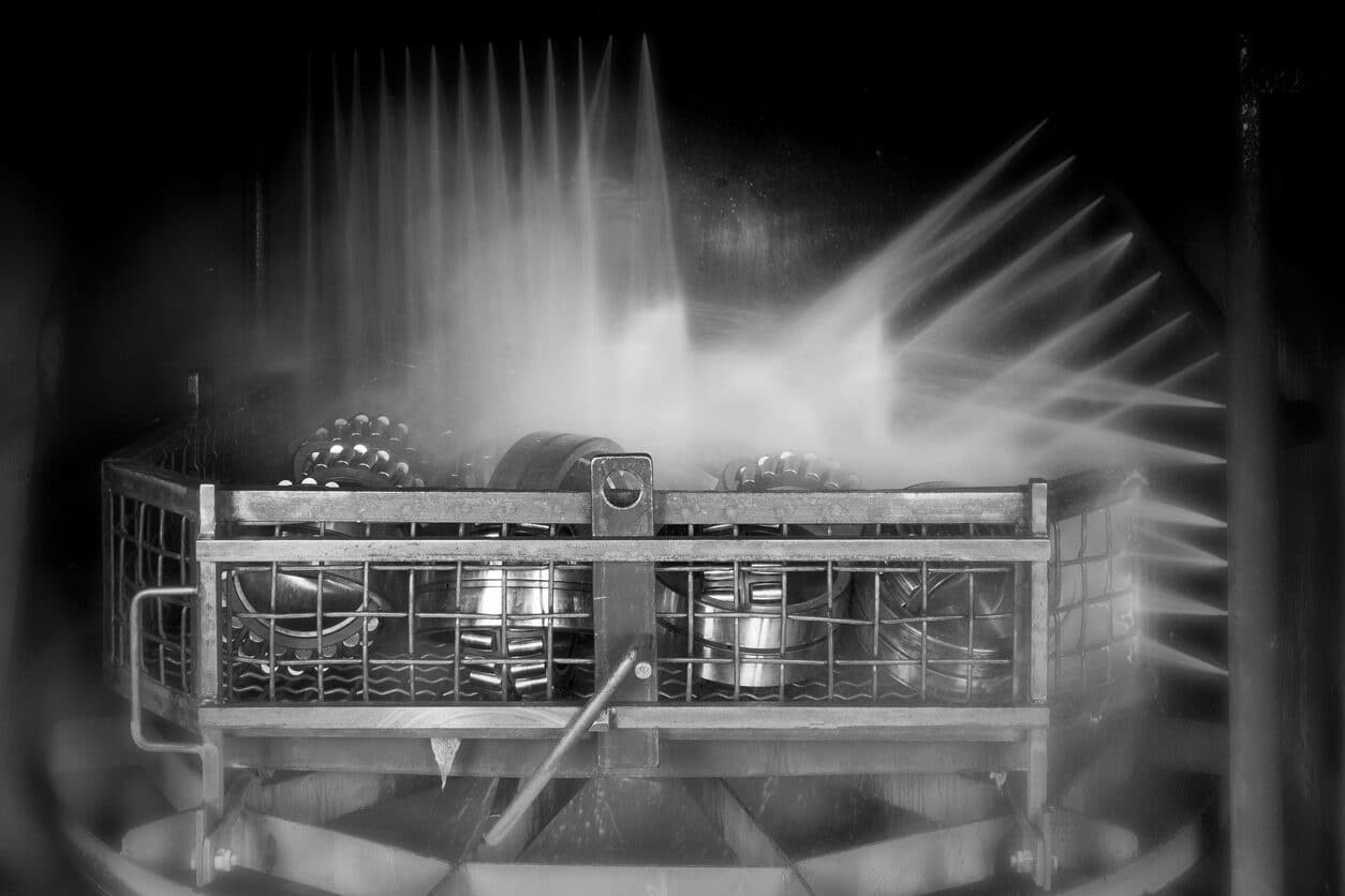 Ball bearings being decreased in industrial part washing system.