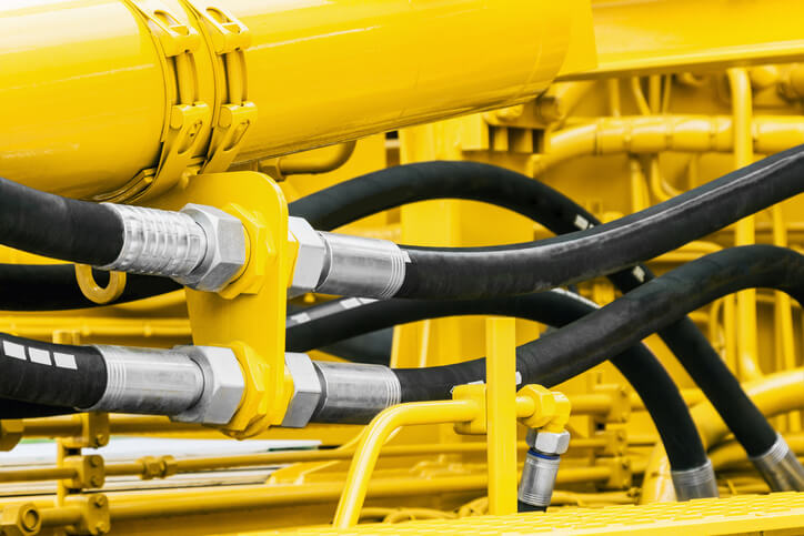 Yellow, hydraulic lines attached to tractor.