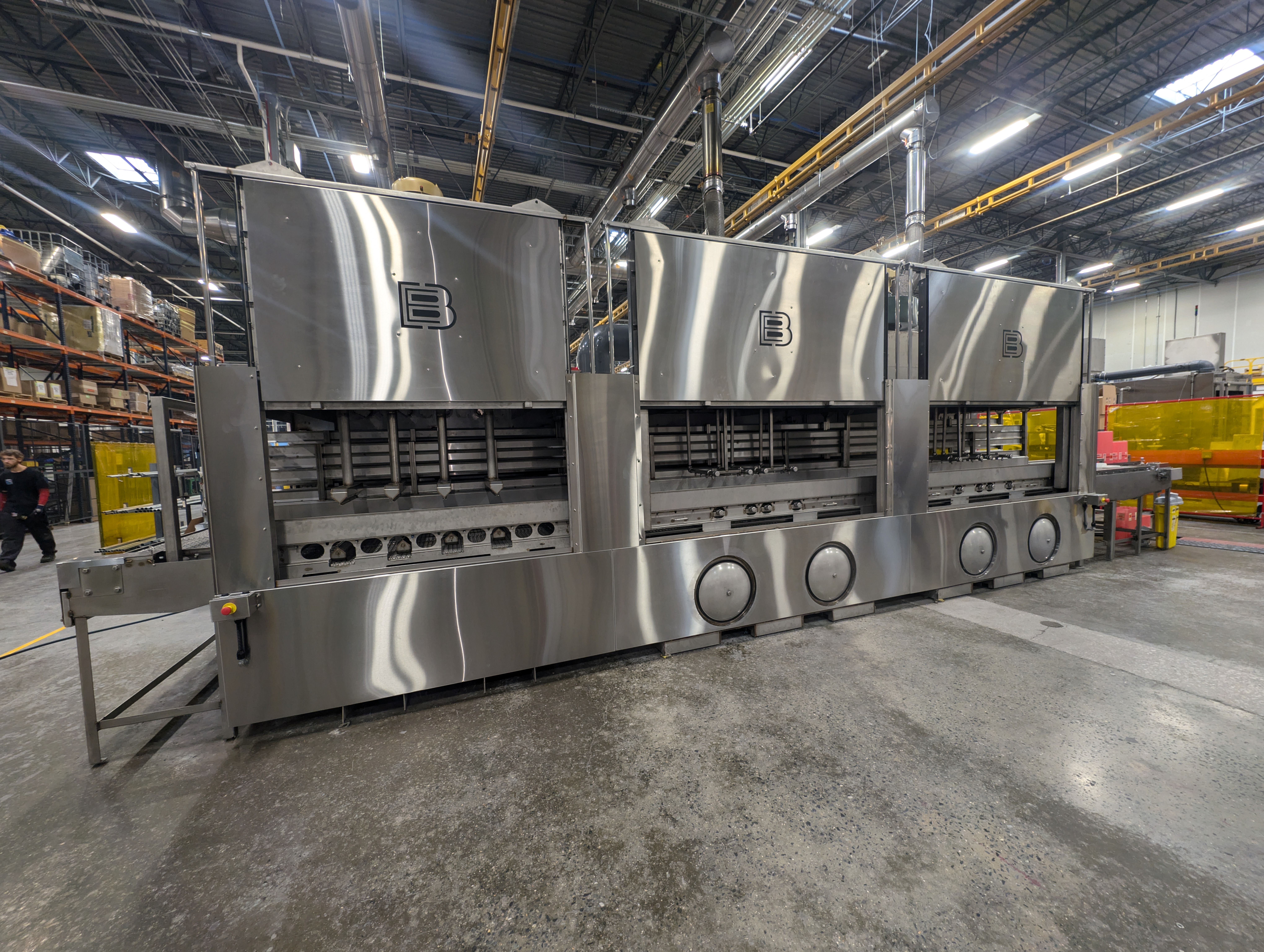 Stainless steel, triple-lane sanitizing tunnel washer built to clean medical waste totes, bins, and lids.