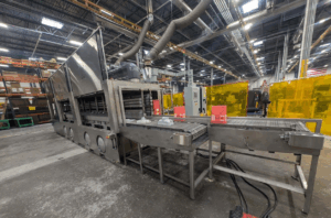 Triple-lane sanitizing tunnel washer built to clean medical waste totes, bins, and lids.