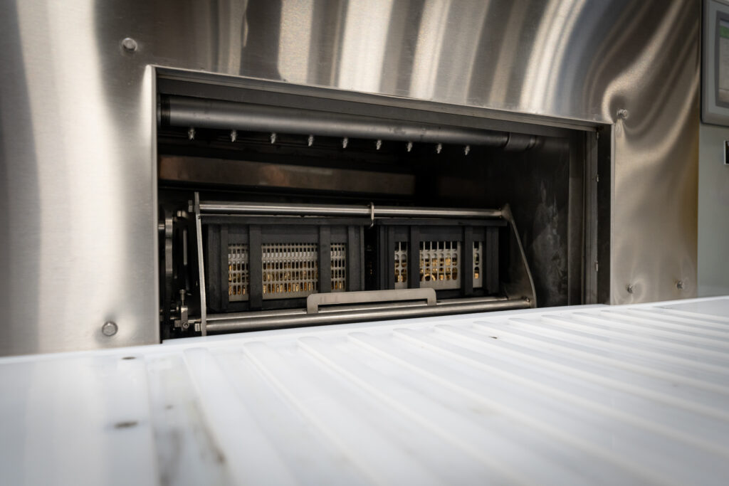 Cyclojet rotary parts washer designed to clean bin components.