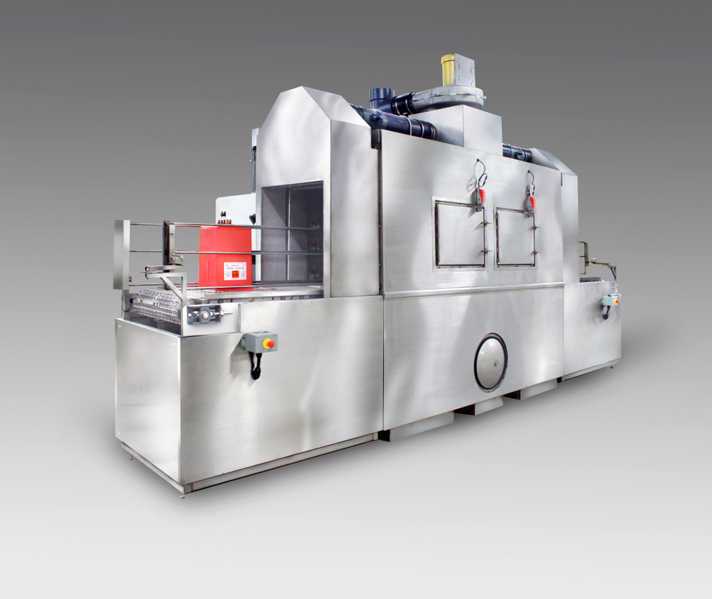 Conveyor part washer designed for cleaning medical totes, bins, and Sharps Containers.