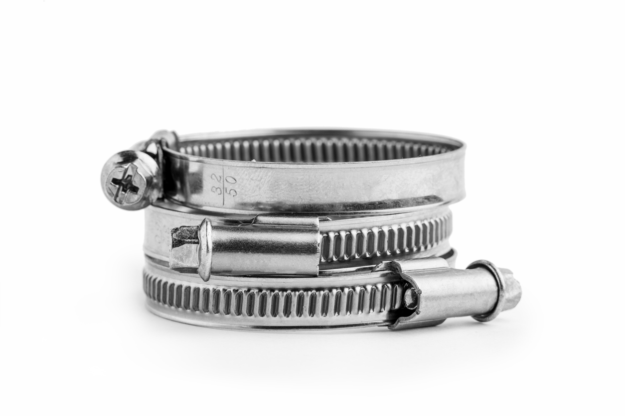 Different metal clamps for hose connection isolated on white background close up