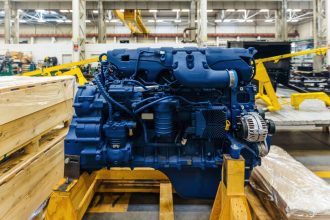 Diesel Engine | Better Engineering Blue diesel engine sitting on wood planks, waiting for installation.