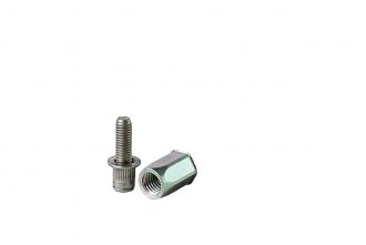 Two parts of a metal pop Rivet fastener on a grey cement background.