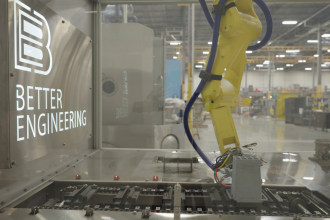 Industrial robotic arm operating inside a Better Engineering automated manufacturing system.